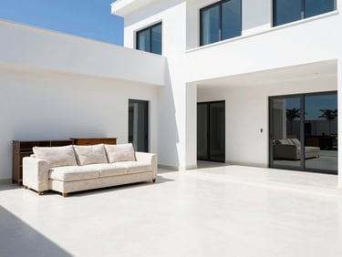 Crisp daylight shot of a clean modern Dubai villa living room with unwanted old furniture neatly stacked for removal, bright high-key commercial photography.