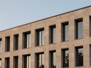 Architectural elevation of a modern commercial facade, clean geometric lines, premium sand-beige stone cladding, twilight sky, sharp focus, editorial photography