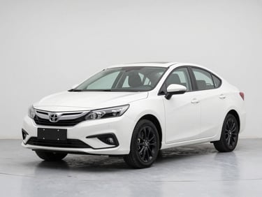 Front three-quarter view of a white mid-size saloon on a clean studio floor, bright diffused daylight, black alloy wheels, sharp paint reflections, minimal background