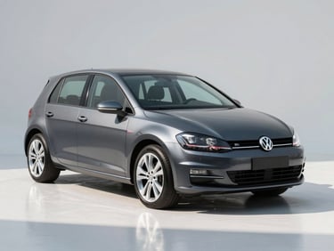 Three-quarter front view of a dark grey Volkswagen Golf on a clean white studio floor, sharp daylight, chrome wheels reflecting floor light, no background clutter