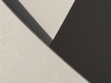 Macro close-up of sharp architectural concrete folds with hard diagonal shadows, minimalist composition, neutral tones, 50mm