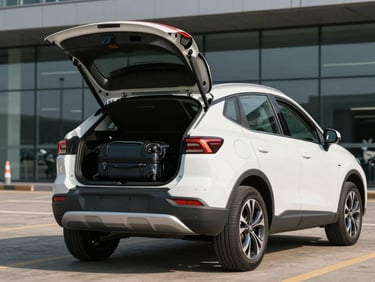Three-quarter front of a compact SUV in white on a daylit airport curb, luggage space open, clean tyres and bodywork