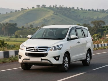 Three-quarter front view of a clean white Toyota Innova on a Karnataka highway at morning light, green hill landscape in background, road markings sharp, no other vehicles, functional documentary framing