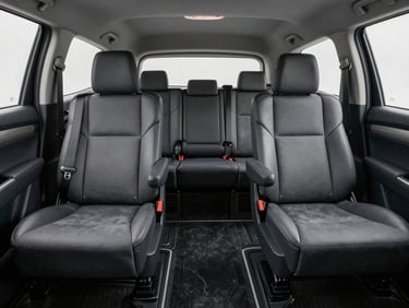 Interior cabin of a clean Toyota Innova showing neat headrests and spotless floor mats under soft daylight from side windows, no passengers