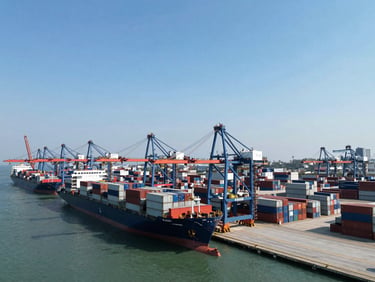 Wide-angle aerial shot of a modern container terminal port with cargo ships under natural daylight, steel gray tones
