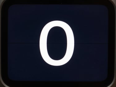 Extreme close-up of a minimal Android timer interface on a dark screen, single large digit, high-contrast UI elements on deep background, studio neutral light