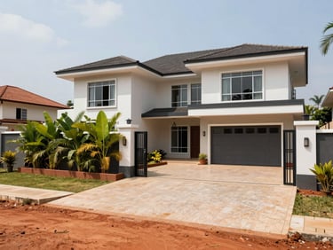 Wide-angle exterior photograph of a modern residential villa in Bangui, bright natural equatorial daylight, red laterite soil visible at the edge of the clean paved courtyard, secure gated entrance with green tropical foliage.