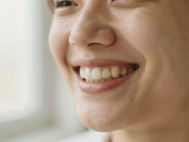 Close-up portrait of a patient with perfectly aligned teeth, laughing naturally, warm editorial lighting, shallow depth of field, 35mm