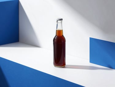High-key studio product photography of a sleek glass bottle of cold brew coffee resting on a clean white surface with sharp blue lighting accents, 35mm