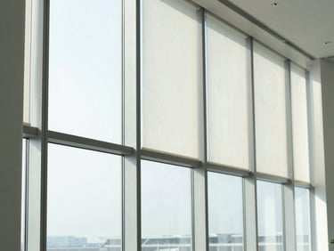 Modern floor-to-ceiling office windows featuring vertical fabric bands partially rotated to control incoming sunlight, clean architectural lines, 35mm