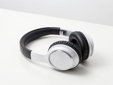 Over-ear noise-canceling headphones resting on a clean white desk, crisp studio lighting, sharp focus