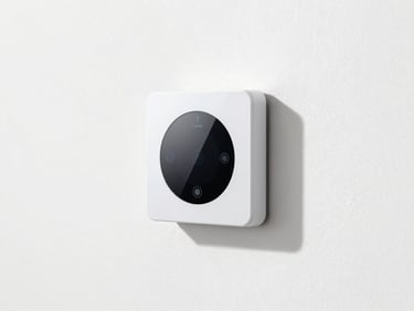 A sleek smart thermostat mounted on a clean white wall, bright natural daylight, modern minimalist aesthetic