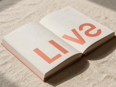A thick editorial coffee table book open on a raw linen surface, showcasing high-contrast minimalist typography and layout design, warm daylight
