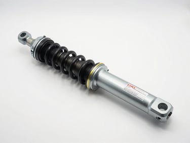 Studio shot of a front suspension strut assembly laid flat on white, OEM part label readable, bright even lighting with shadow definition
