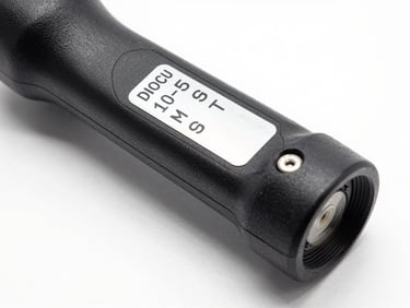 Close-up studio shot of a steering rack assembly on white surface, part identification label clearly readable, sharp shadow definition from studio strobe