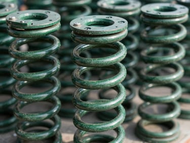Close-up of a new, heavy-duty garage door torsion spring, brightly lit, sharp focus, showing the coil and mounting hardware.