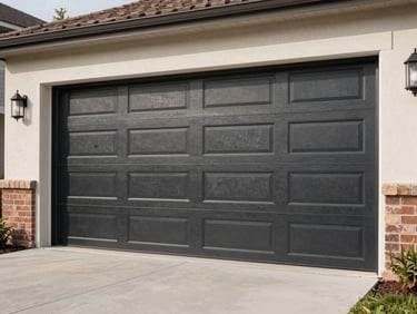Wide shot of a brand-new dark charcoal carriage-style garage door being fitted into a residential garage opening, exterior daylight, no people visible, clean suburban driveway