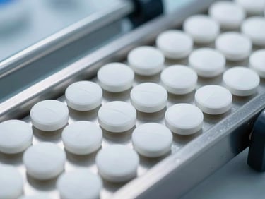 Close-up of pristine white pharmaceutical tablets on a stainless steel conveyor belt under bright, cool laboratory lighting, sharp macro focus, 35mm