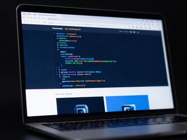 High-contrast studio shot of a laptop screen displaying a fast-loading website, with a subtle blur of code in the background, sleek editorial technology photography, cool high-contrast studio lighting, deep slate and electric blue tones, macro 50mm