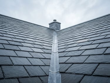 Low-angle architectural shot of a perfectly aligned natural slate roof against a crisp overcast sky, sharp focus, 35mm lens