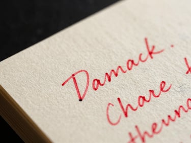 Extreme macro close-up of a script margin, textured cream paper with handwritten red ink annotations, high-contrast low-key lighting, shallow depth of field focusing on a single sharp correction.