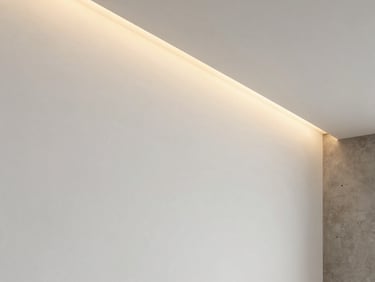 Close-up of a flawless matte white interior wall meeting a clean ceiling line, soft architectural shadows, highlighting perfect plaster finish texture.