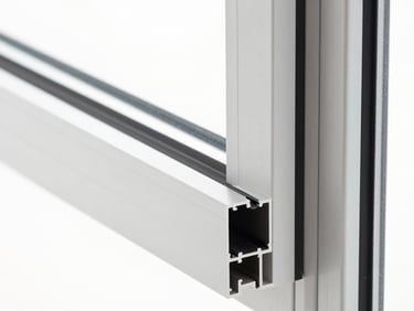 Close-up of a sleek, slim-profile aluminium window frame corner joint, emphasizing structural integrity and modern design.