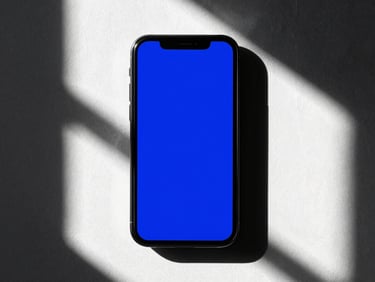 High-contrast 35mm editorial shot of a mobile screen displaying a bold electric blue ad mockup, dramatic natural window light, deep shadows