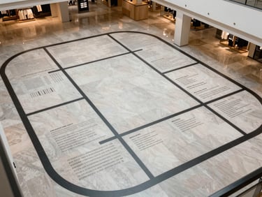 Architectural overhead view of a commercial interior wayfinding system installed in a large retail space, crisp daylight, geometric floor plan visible, no people
