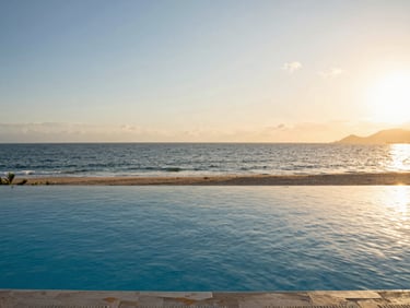 Editorial photo of an infinity pool overlooking Banderas Bay in Puerto Vallarta, sunset light