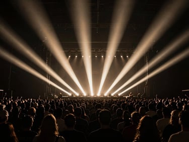 Wide-angle panoramic shot of a massive, perfectly ordered concert crowd under sharp champagne-colored light beams cutting through deep anthracite darkness, high-contrast chiaroscuro, 35mm.