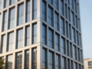 Sleek commercial property facade with clean architectural lines, bright morning light, professional real estate photography.
