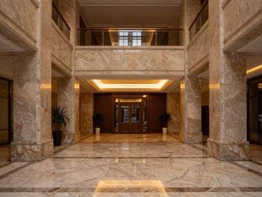 Symmetrical architectural shot of a luxury apartment lobby with marble floors and warm ambient lighting, clean lines, medium format