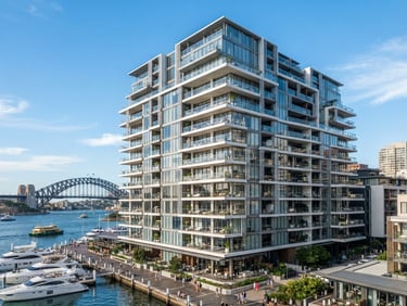 Bright architectural photo of Sydney harbor apartment building exterior, crisp natural daylight, clean geometric lines, 35mm lens