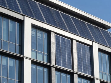 Modern commercial building facade with sleek solar panels integrated into the architecture, bright sunlight, crisp steel and glass details