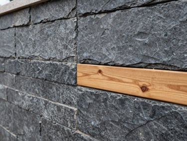 Close-up of a perfectly aligned slate gray retaining wall with clean joints, wet-look stone after rain, architectural photography