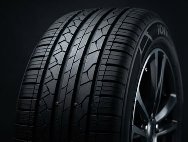 Macro shot of a pristine Hankook iON electric vehicle tire tread, clean metallic textures, high-contrast studio lighting, deep charcoal background, sharp focus, 85mm lens