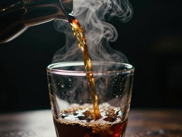 A close-up of coffee pouring into a glass cup, steam rising, backlit by a soft golden studio light