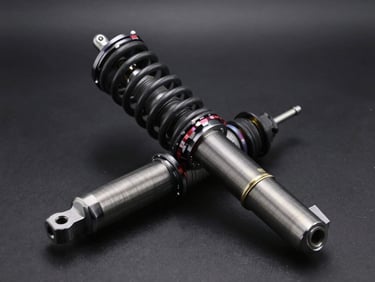 Heavy-duty automotive suspension shock absorber and coil spring, industrial finish, crisp highlights