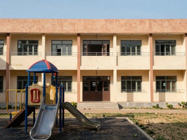 A modern school building facade with a clean playground in Hanumangarh, bright sunny day
