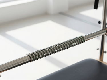 Close-up of a polished Pilates spring with green-tinted steel, reflecting bright, clean daylight in a modern studio.