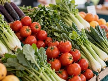 Vibrant display of organic fresh produce at a local farmers market, colorful vegetables and fruits, soft daylight, wide environmental shot.