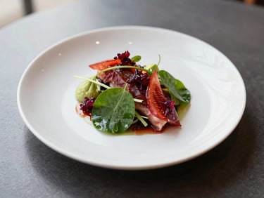 Overhead shot of a beautifully plated gourmet dish with fresh, vibrant ingredients, set on a dark, minimalist table, soft north-facing daylight, shallow depth of field.