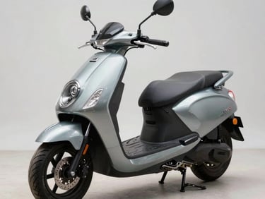 45-degree quartering shot of a 150cc commuter scooter on a clean studio surface, neutral daylight revealing the front apron, headlamp cluster, and instrument console detail, no rider present