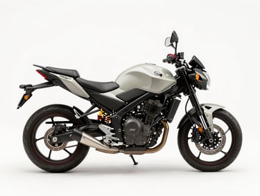 Overhead studio shot of a 160cc naked street motorcycle, neutral white surface, even daylight, full bike visible from above showing tank and instrument cluster