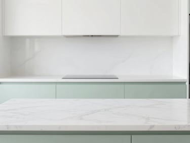 Bright high-key interior of a modern kitchen with empty marble countertops, clean white and soft green tones, sharp focus, 35mm