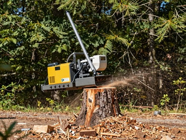 Heavy-duty stump grinding machine turning a massive pine stump into clean mulch, wood chips flying safely, daylight.