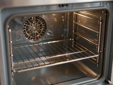 Close-up interior shot of a spotless oven cavity, racks gleaming, interior walls clean and grease-free, bright direct light showing every surface, documentary framing with no styling
