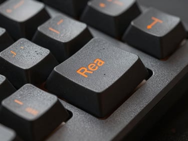 Macro studio shot of a mechanical keyboard keycap with sharp orange legend, dark grey aluminum frame, low-key lighting