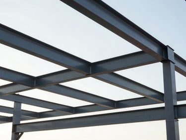 Active, highly organized construction job site, clean framing of structural steel beams against a bright morning sky, no debris.